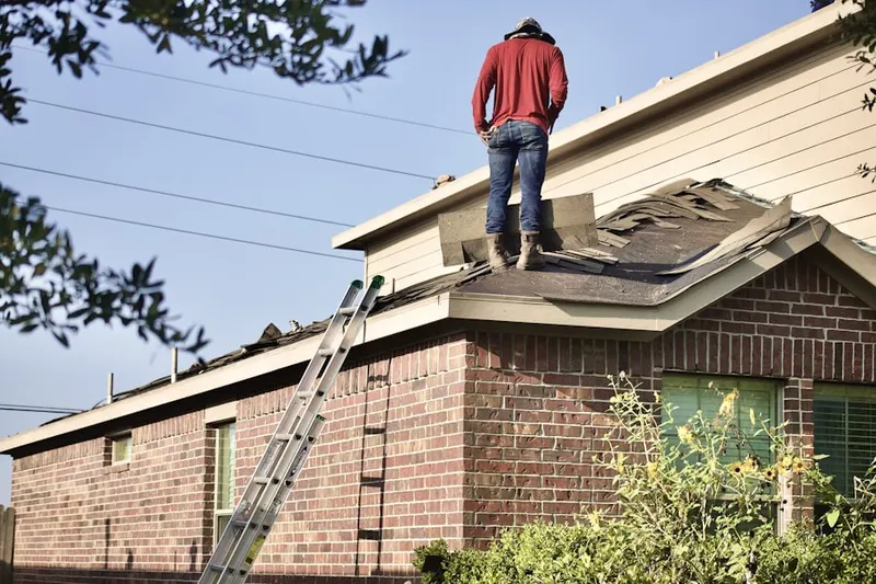 Professional roofer working on a residential roof in Valley Mills